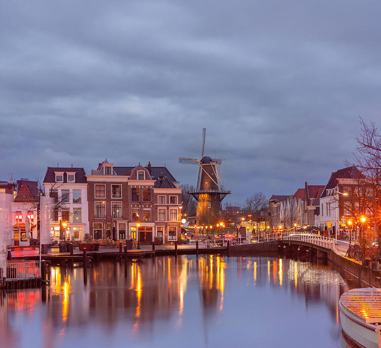 Leiden canal with Blauwpoortsbrug bridge and Windmill De Valk, South Holland, Netherlands
